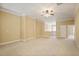 Spacious living room with plush carpeting, crown molding, and staircase access at 10462 Bent Tree Vw, Duluth, GA 30097