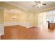 Bright and airy living room with hardwood floors and open layout to the kitchen and dining areas at 10462 Bent Tree Vw, Duluth, GA 30097