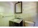 Bathroom with vintage black and marble vanity and a black framed mirror at 1815 Windsor Sw Dr, Atlanta, GA 30311