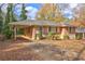 Charming brick house with mature trees, a covered carport, and a driveway at 1815 Windsor Sw Dr, Atlanta, GA 30311