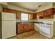 Efficient kitchen featuring wood cabinets, essential appliances, and ample counter space, ideal for meal preparation at 1815 Windsor Sw Dr, Atlanta, GA 30311
