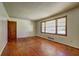 Living room featuring hardwood floors, natural light, neutral paint, and detailed trim providing a relaxing atmosphere at 1815 Windsor Sw Dr, Atlanta, GA 30311