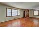 Spacious living room with large windows, hardwood floors, and a decorative divider, creating a warm and inviting ambiance at 1815 Windsor Sw Dr, Atlanta, GA 30311
