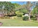 Expansive backyard featuring lush greenery, mature trees, and a garden shed at 3740 Laurel Brook Way, Snellville, GA 30039