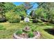 A lush backyard featuring mature trees, green grass and a garden shed at 3740 Laurel Brook Way, Snellville, GA 30039