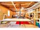 Unfinished basement with exposed wood, shelving, and large table, ready for customization at 3740 Laurel Brook Way, Snellville, GA 30039