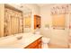 Bathroom with floral curtains, wooden cabinets and a mirror at 3740 Laurel Brook Way, Snellville, GA 30039