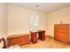 Neutral bedroom featuring a traditional desk and a wooden dresser at 3740 Laurel Brook Way, Snellville, GA 30039