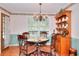 Dining room with classic chandelier, patterned wallpaper, and hardwood floors at 3740 Laurel Brook Way, Snellville, GA 30039