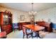 Formal dining room with hardwood table, chairs, and chandelier at 3740 Laurel Brook Way, Snellville, GA 30039