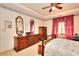 Main bedroom with floral design, hard wood furnishings and a ceiling fan at 3740 Laurel Brook Way, Snellville, GA 30039