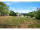 Expansive backyard featuring a lush lawn, a charming shed, and privacy fencing, perfect for outdoor activities and relaxation at 4030 Scenic View Ct, Cumming, GA 30028