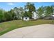 Spacious backyard with a shed, bordered by mature trees, with a patio, offering a private and peaceful outdoor retreat at 4030 Scenic View Ct, Cumming, GA 30028