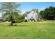 Picturesque backyard with a manicured lawn, a black fence, and mature trees, creating a serene and private outdoor space at 4030 Scenic View Ct, Cumming, GA 30028