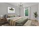 Bright bedroom featuring hardwood floors, a contemporary light fixture, and a large window providing a view of nature at 4030 Scenic View Ct, Cumming, GA 30028