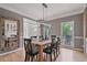 Dining room featuring a wood table, modern lighting, and a view of the front entryway and outdoor greenery at 4030 Scenic View Ct, Cumming, GA 30028