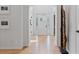 Bright entryway with white walls, hardwood floors, and a white front door with glass panes at 4030 Scenic View Ct, Cumming, GA 30028