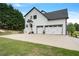 Charming home with white siding, a 3 car garage and a well-manicured lawn and landscaping at 4030 Scenic View Ct, Cumming, GA 30028