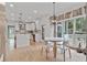 Bright kitchen and breakfast nook with white cabinets, quartz countertops, and stainless steel appliances at 4030 Scenic View Ct, Cumming, GA 30028