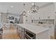 Open kitchen featuring a large quartz island, stainless appliances, and modern pendant lighting at 4030 Scenic View Ct, Cumming, GA 30028