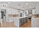 Modern kitchen with white cabinets, a gray island, stainless steel appliances and hardwood floors at 4030 Scenic View Ct, Cumming, GA 30028