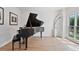 Bright living room with hardwood floors, a large window, and a grand piano at 4030 Scenic View Ct, Cumming, GA 30028