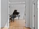 Bright living room with hardwood floors, a large window, and a grand piano at 4030 Scenic View Ct, Cumming, GA 30028