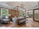 Spacious main bedroom with wood paneling, hardwood floors, tray ceilings and a seating area at 4030 Scenic View Ct, Cumming, GA 30028