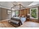 A spacious main bedroom with a four-post bed frame, hardwood floors and plenty of natural light at 4030 Scenic View Ct, Cumming, GA 30028