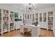 Bright office space featuring hardwood floors, built-in bookshelves, and a modern light fixture at 4030 Scenic View Ct, Cumming, GA 30028
