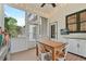 Enclosed porch with ceiling fan, a dining table, and bar stool seating, with an exterior view at 4030 Scenic View Ct, Cumming, GA 30028