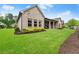A home's backyard featuring a well-maintained lawn and beautiful landscaping that enhances the property's curb appeal at 4815 Amble Trce, Cumming, GA 30040