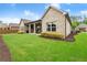 The house's backyard showcases a lush lawn and beautiful landscaping adding to the charm of the property at 4815 Amble Trce, Cumming, GA 30040