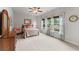 Bright bedroom featuring large windows, neutral decor, and a ceiling fan at 4815 Amble Trce, Cumming, GA 30040