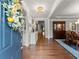 Inviting foyer featuring hardwood floors, crown molding, and a view into the dining room exudes sophisticated charm at 4815 Amble Trce, Cumming, GA 30040