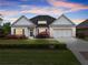 Beautiful brick home with a manicured lawn, blue shutters, and an attached two car garage at 4815 Amble Trce, Cumming, GA 30040