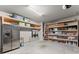 Spacious garage with ample shelving and an extra refrigerator for added convenience at 4815 Amble Trce, Cumming, GA 30040