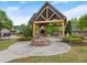 Beautiful gazebo with chairs and fire pit surrounded by mature landscaping at 4815 Amble Trce, Cumming, GA 30040