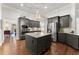 Modern kitchen boasts an island, granite countertops, stainless steel appliances, and ample storage space at 4815 Amble Trce, Cumming, GA 30040