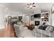 Spacious living room showcases a fireplace, built-in shelving, and flows into the modern kitchen for seamless living at 4815 Amble Trce, Cumming, GA 30040