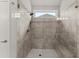 The walk-in shower features tile walls and a built-in bench at 4815 Amble Trce, Cumming, GA 30040