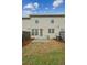 View of the back of the house with fenced yard, patio, and grassy area at 6595 Story Cir, Norcross, GA 30093