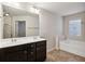 Bathroom with a double sink vanity, a soaking tub, and a shower at 6595 Story Cir, Norcross, GA 30093