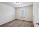 Bedroom with a window providing natural light and neutral carpet at 6595 Story Cir, Norcross, GA 30093