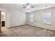 Primary bedroom with neutral carpet, ceiling fan, and natural light at 6595 Story Cir, Norcross, GA 30093