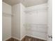 Walk-in closet featuring built-in shelving units and carpet at 6595 Story Cir, Norcross, GA 30093