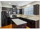 Elegant kitchen with black appliances, granite counters, and an island for extra counter space at 6595 Story Cir, Norcross, GA 30093