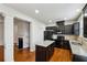 Modern kitchen featuring dark cabinetry, granite countertops, and stainless steel appliances at 6595 Story Cir, Norcross, GA 30093