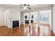 Spacious living room with hardwood floors, a fireplace, and open layout to the kitchen at 6595 Story Cir, Norcross, GA 30093