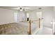 Open and bright loft area with neutral carpet and a ceiling fan at 6595 Story Cir, Norcross, GA 30093